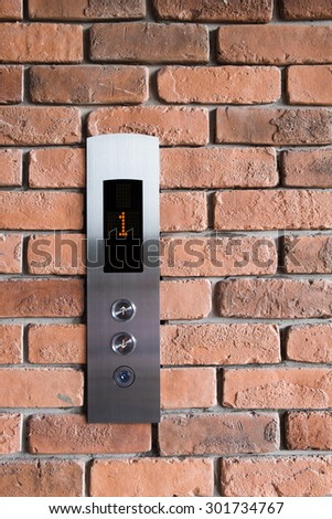 Elevators Panel on brick wall texture