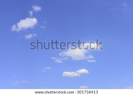 On a few white clouds, blue sky close-up 