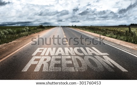 Financial Freedom written on rural road Royalty-Free Stock Photo #301760453