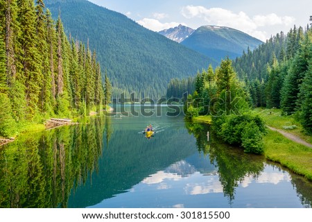 Majestic mountain lake in Canada. Lightning Lake in Manning Park in British Columbia. Boat. Royalty-Free Stock Photo #301815500