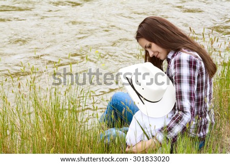 Mother and toddler son sitting by the riverside