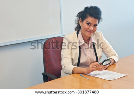 Business woman examine contract details by magnifier