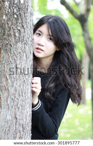 Portrait of thai student teen beautiful girl Black Dresses relax in park.
