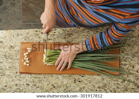 Chopping green onions in a modern kitchen