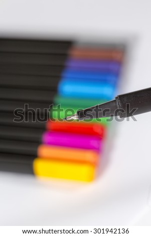 Image for Back to school theme. An image of colorful pencils against a white paper. Image has a lot of space for a text.