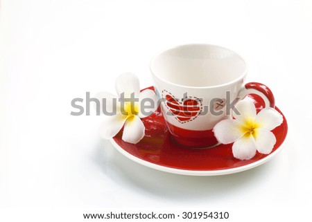 A cup with  heart and flowers on soft background.