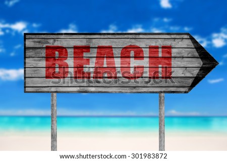 Red Beach wooden sign with on beach background