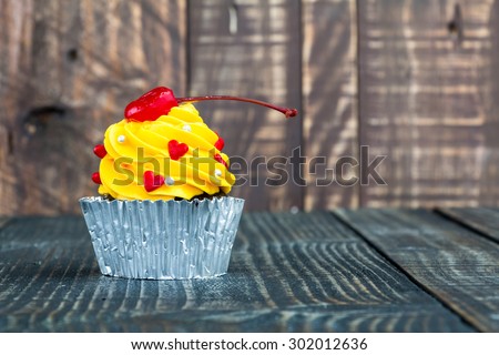Cupcake on wooden background