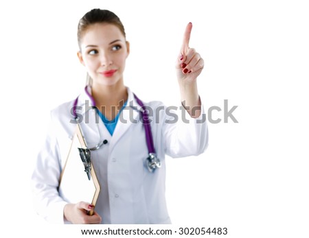 Woman doctor standing with folder at hospital and pointing up
