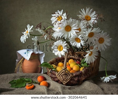 Still life with bouquet of chamomiles and apricots