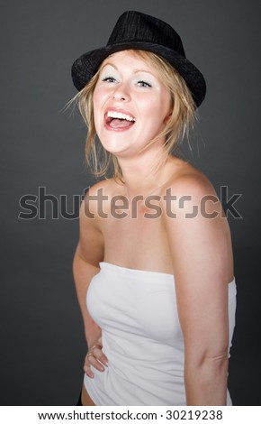 Shot of a Beautiful Blonde Girl in Hat against Grey Background