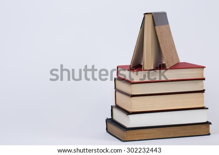 A simple yet eloquent pile of books. With a plain white background, this is a nice photo that has many educational applications for various ideas and concepts around the world. 