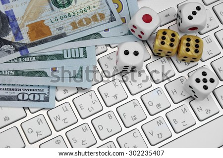 Computer Keyboard Close-up,  Gaming Dices And USA Dollar Cash.  On Line Gambling Game Concept