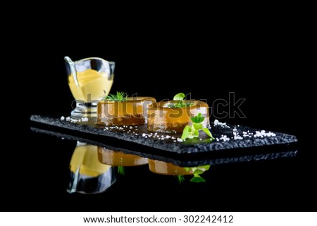 beef aspic with souce on black background