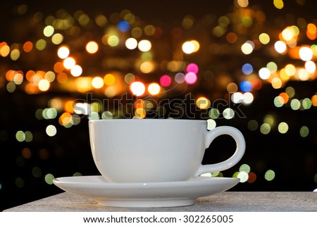 Hot coffee on the bokeh light background.