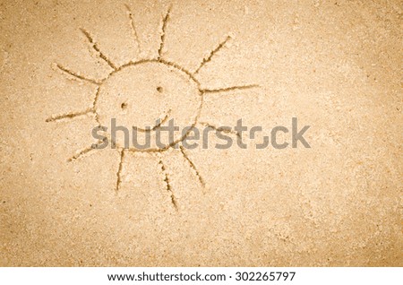 sun shape drawing on sand