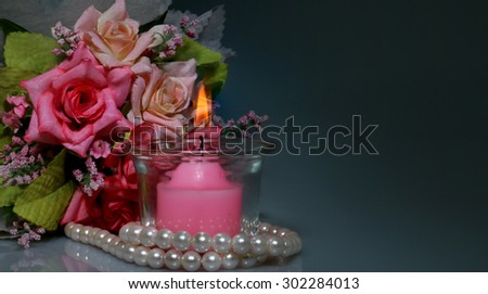candle and  Sweet pastel rose flowers 