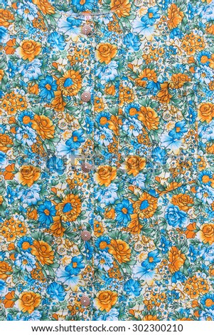 Thai country style classic vintage orange rose and blue flower pattern on shirt background