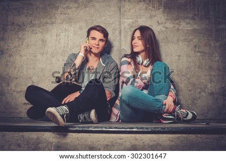 Young couple with skateboard  outdoors 