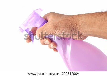 Spray bottle by hand on white background.