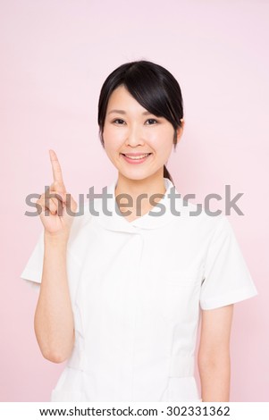 young nurse woman against pink background