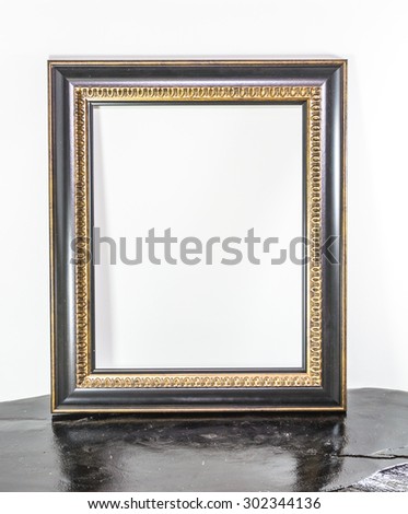 Vintage picture frame on wood and on white background.