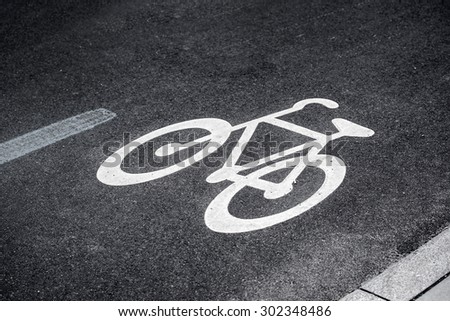Bike Lane Sign on Asphalt Road Marking the Space for Cycling in Urban Outdoor Setting