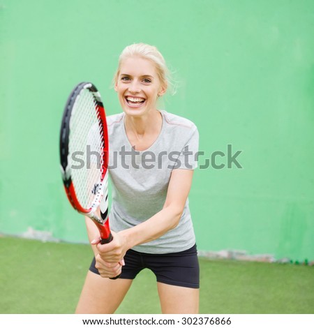 Girl tennis player on the court with a racket. Athletic, health, sports, lifestyle.