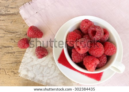 Ripe raspberries in a cup