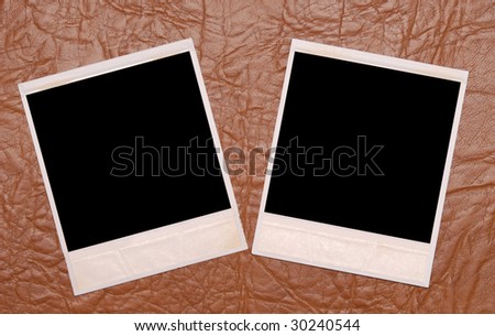 two photo frames on a leather background