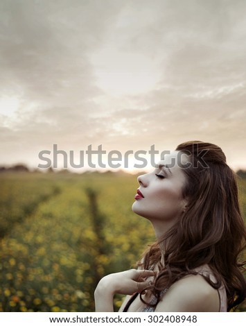 Beautiful woman on summer flower meadow