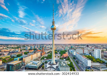 Aerial view of Berlin skyline with famous TV tower at Alexanderplatz and dramatic cloudscape at sunset, Germany Royalty-Free Stock Photo #302414933