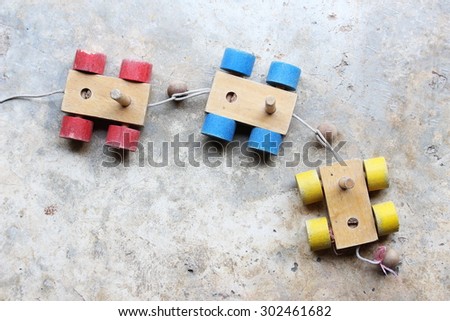 Old colorful wooden toy train on concrete floor
