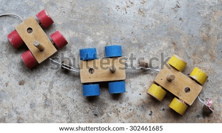  Old colorful wooden toy train on concrete floor