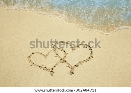 a two hearts in the sand on the beach