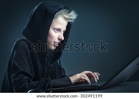 Teenager sitting behind a computer