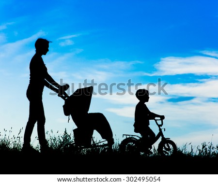 silhouette mother with children walking 