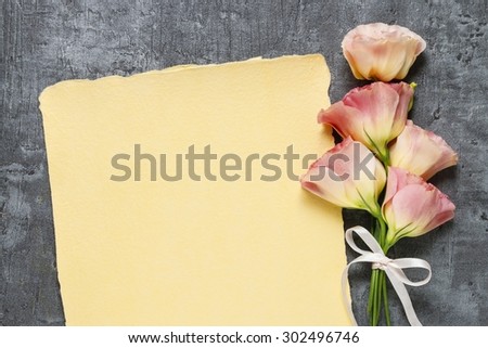 Pink eustoma flowers and vintage paper, copy space