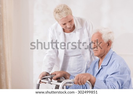 Image of disabled old patient with walking zimmer