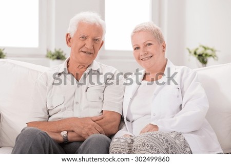 Picture of happy elderly man with his nurse