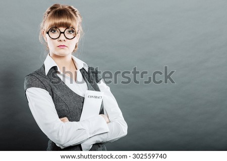 Business documents legal concept - closeup serious businesswoman holding contract in hand