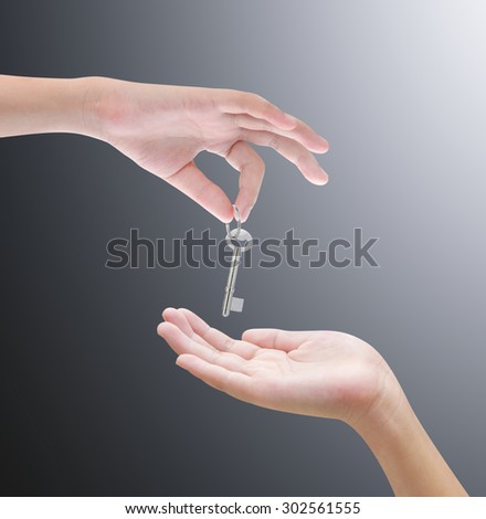 Hand holding key on white background