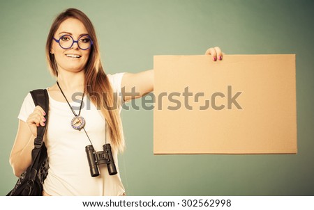 Travel and tourism active lifestyle concept. Woman tourist hitchhiking with blank sign for text filtered photo
