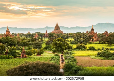 Amazing famous travel and landscape scene of ancient temples and carriages at sunset in Bagan, Myanmar. Top of the best destination of asia. Royalty-Free Stock Photo #302572958
