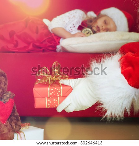 Sweet little girl sleeps in Santa caps