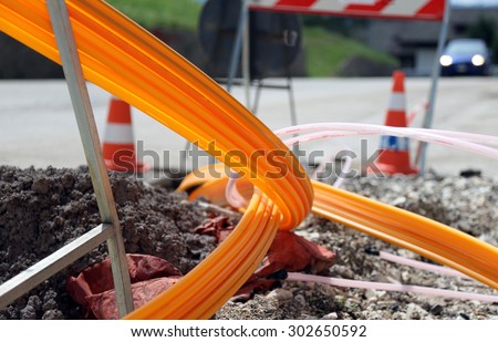 road excavation for the laying of optical fiber for very high speed internet Royalty-Free Stock Photo #302650592