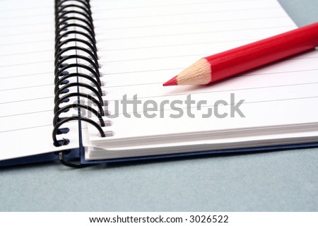 red pencil on notebook