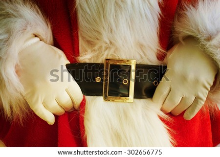 Midsection of Santa Claus with hands on stomach