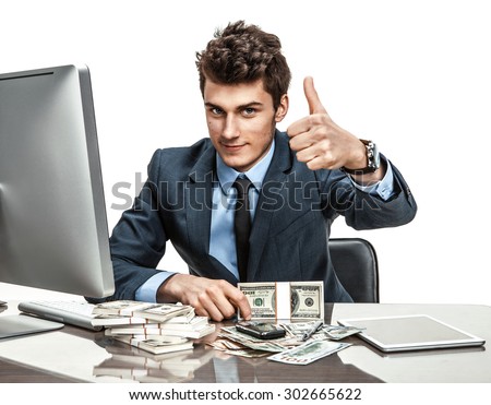 Cheerful chief showing thumbs up success sign / modern businessman at the workplace working with computer Royalty-Free Stock Photo #302665622