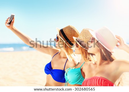 A picture of a group of friends taking selfie on the beach